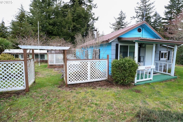 rear view of property with a lawn