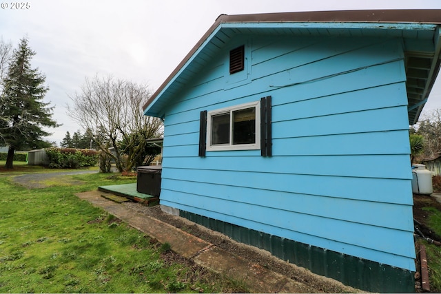 view of side of home with a yard