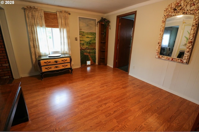 empty room with hardwood / wood-style flooring and ornamental molding