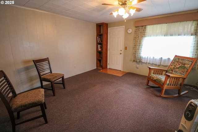 living area with carpet flooring and ceiling fan