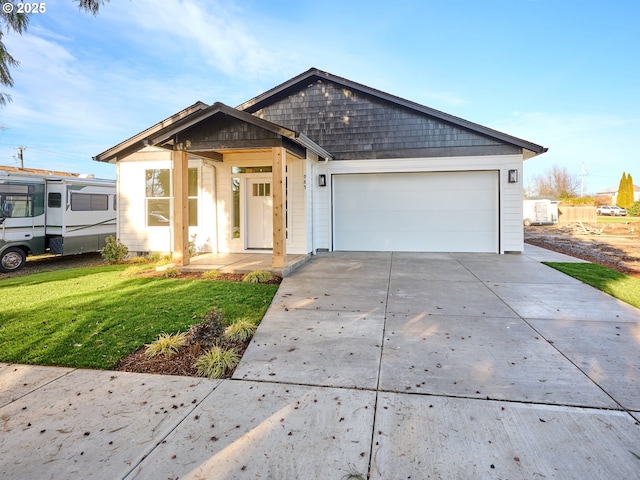 view of front of house with a garage and a front lawn