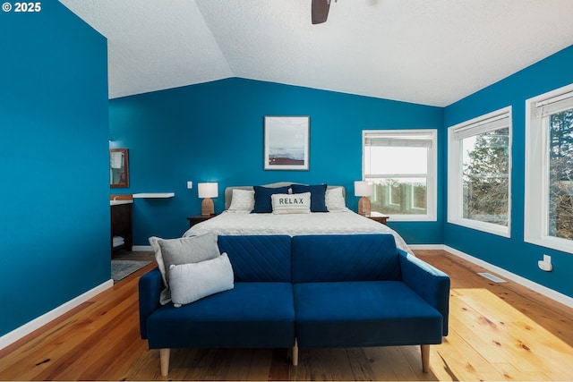 bedroom with vaulted ceiling, hardwood / wood-style floors, and ceiling fan