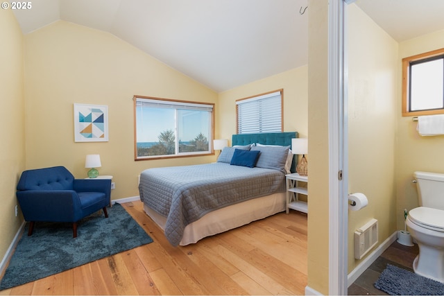 bedroom with hardwood / wood-style flooring and vaulted ceiling