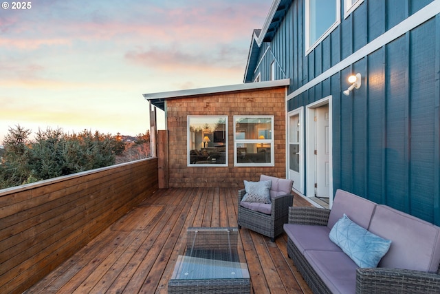 deck at dusk with an outdoor living space