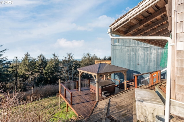 wooden terrace featuring a gazebo