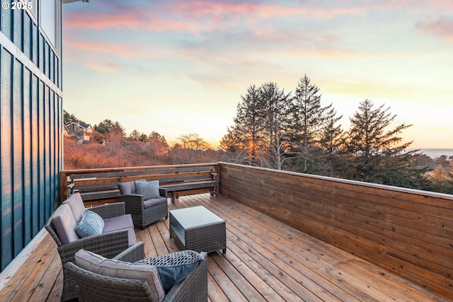 deck at dusk with an outdoor hangout area