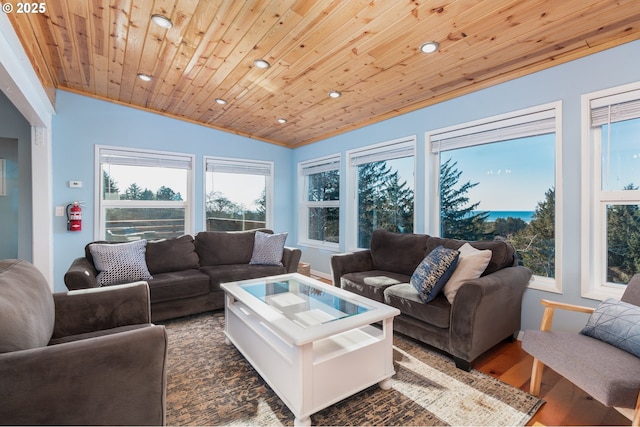 living room featuring lofted ceiling, ornamental molding, dark wood-type flooring, and wooden ceiling