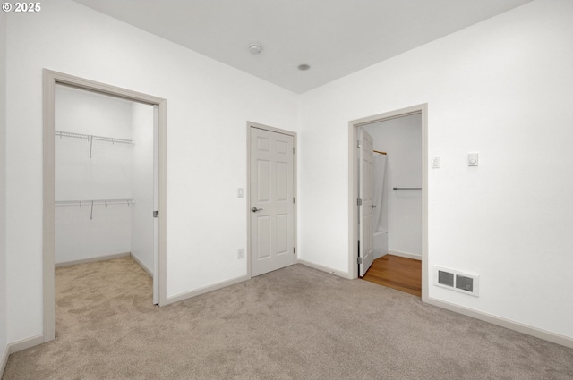 1726 32nd St, Florence, OR 97439 - unfurnished bedroom featuring light colored carpet, a spacious closet, baseboards, a closet, and ensuite bath