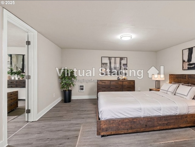 bedroom with hardwood / wood-style flooring