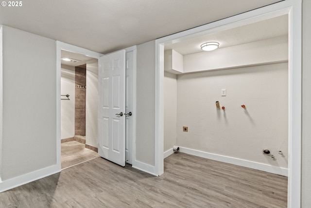 clothes washing area featuring gas dryer hookup, electric dryer hookup, and light hardwood / wood-style floors