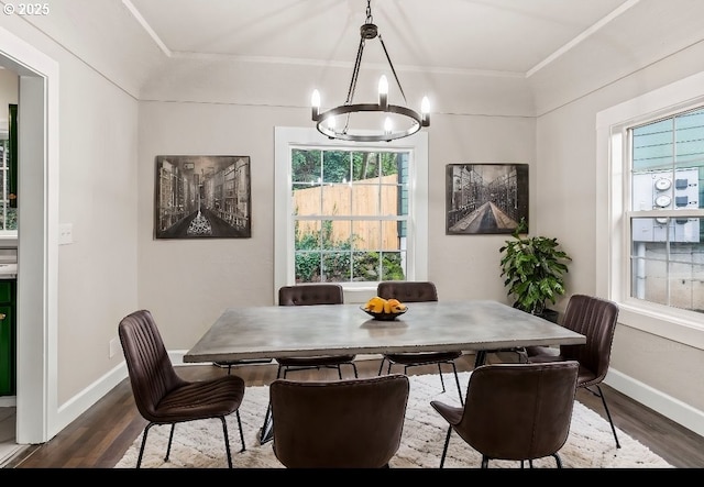 dining area featuring ornamental molding, dark hardwood / wood-style floors, and a chandelier