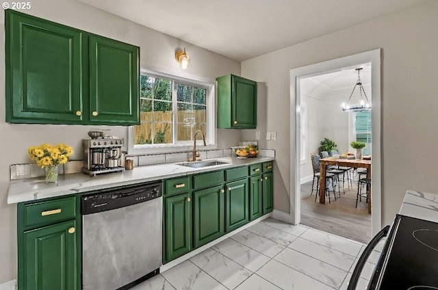 kitchen with sink, range, hanging light fixtures, green cabinetry, and stainless steel dishwasher