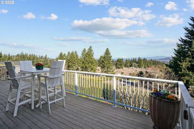 wooden deck featuring outdoor dining area