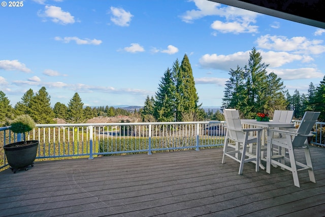 wooden deck featuring outdoor dining area