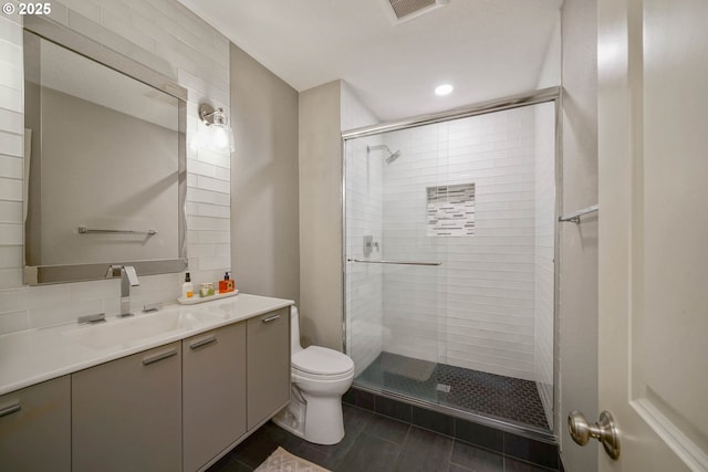 full bathroom with a stall shower, tasteful backsplash, visible vents, toilet, and vanity