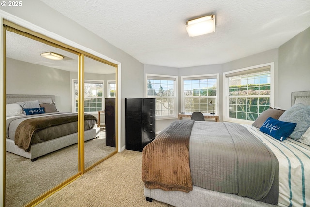 bedroom featuring a textured ceiling, a closet, and carpet flooring