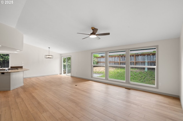 15080 SW 88th Ave, Portland, OR 97224 - unfurnished living room with ceiling fan, lofted ceiling, light wood-type flooring, and a chandelier