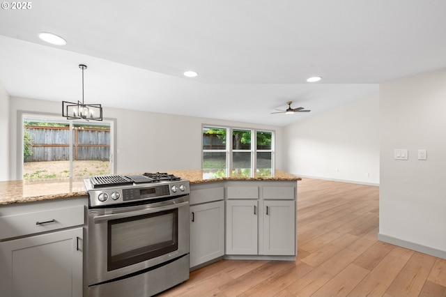 15080 SW 88th Ave, Portland, OR 97224 - kitchen featuring stainless steel gas range oven, light wood-style flooring, a chandelier, light stone counters, and recessed lighting
