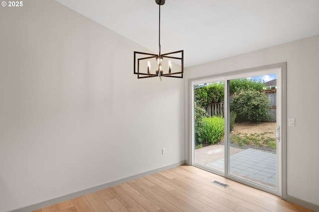 15080 SW 88th Ave, Portland, OR 97224 - unfurnished dining area with light wood-style flooring and a chandelier