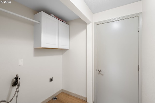 15080 SW 88th Ave, Portland, OR 97224 - laundry area with hookup for an electric dryer, light wood finished floors, and cabinet space
