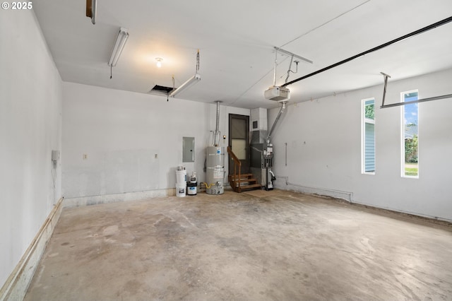 15080 SW 88th Ave, Portland, OR 97224 - garage featuring strapped water heater, electric panel, and a garage door opener