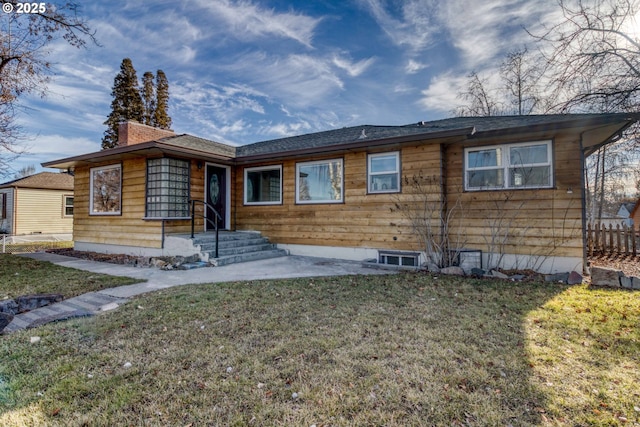 rear view of house featuring a lawn