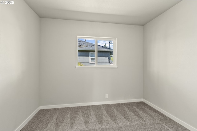 empty room with baseboards and carpet flooring