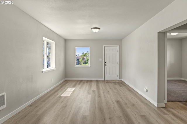 interior space featuring baseboards and light wood-style floors