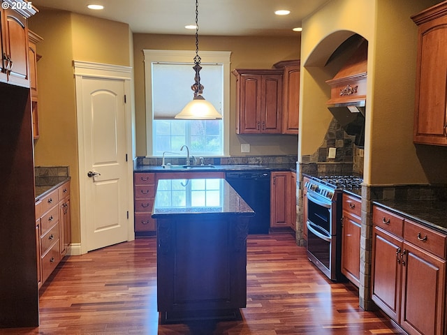 102 Sarah Bear Ln, Winston, OR 97496 - kitchen featuring a center island, dishwasher, dark wood-style floors, and range with two ovens