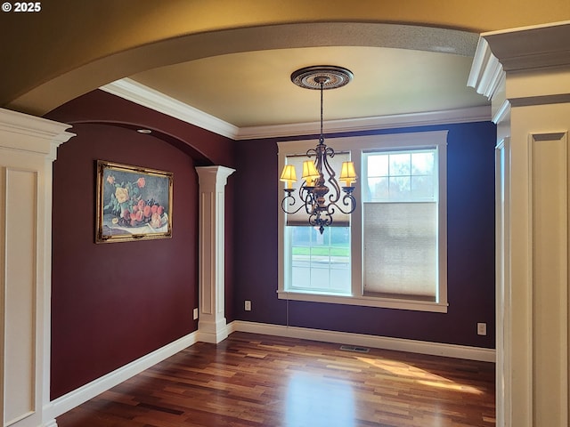 102 Sarah Bear Ln, Winston, OR 97496 - unfurnished dining area featuring an inviting chandelier, arched walkways, ornate columns, and crown molding
