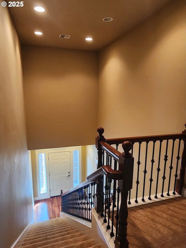 102 Sarah Bear Ln, Winston, OR 97496 - stairway featuring a towering ceiling, wood finished floors, visible vents, and recessed lighting