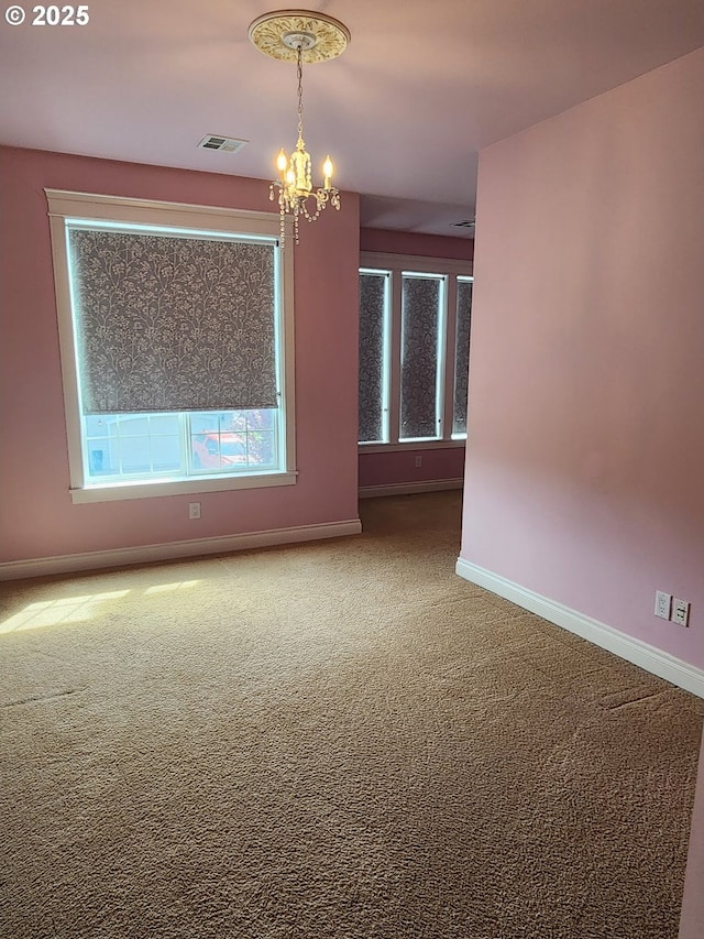 102 Sarah Bear Ln, Winston, OR 97496 - spare room with a chandelier, visible vents, carpet flooring, and baseboards