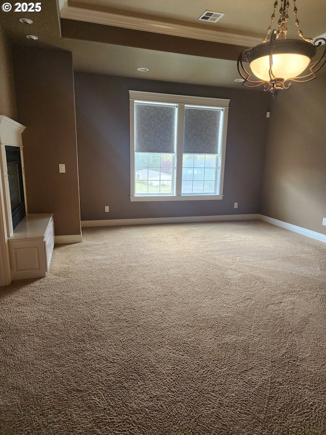 102 Sarah Bear Ln, Winston, OR 97496 - carpeted spare room featuring baseboards, visible vents, a glass covered fireplace, and ornamental molding