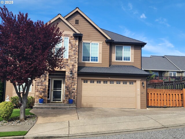 102 Sarah Bear Ln, Winston, OR 97496 - view of front of property with concrete driveway, stone siding, fence, a garage, and roof with shingles