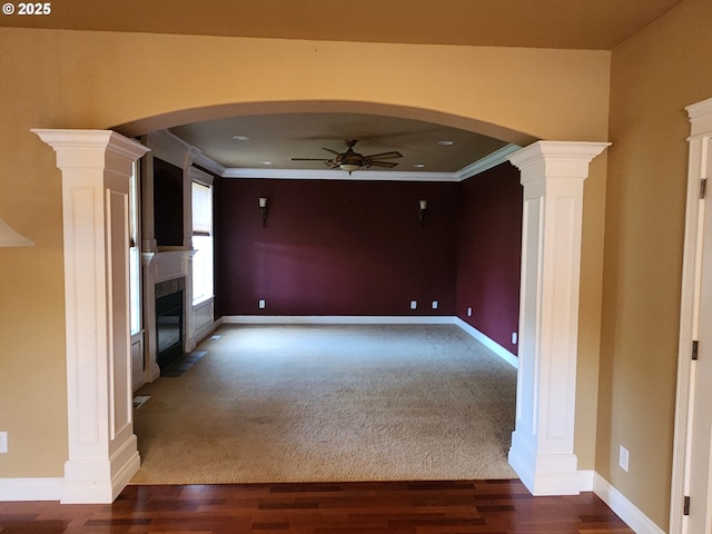 102 Sarah Bear Ln, Winston, OR 97496 - unfurnished living room featuring crown molding, a high end fireplace, ceiling fan, arched walkways, and decorative columns
