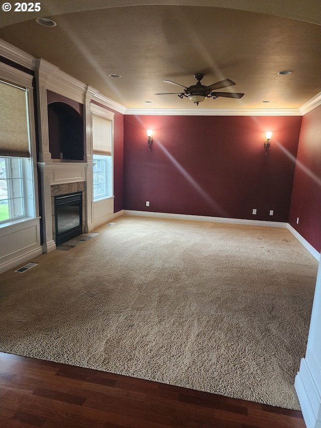 102 Sarah Bear Ln, Winston, OR 97496 - unfurnished living room featuring a tiled fireplace, visible vents, baseboards, a ceiling fan, and crown molding