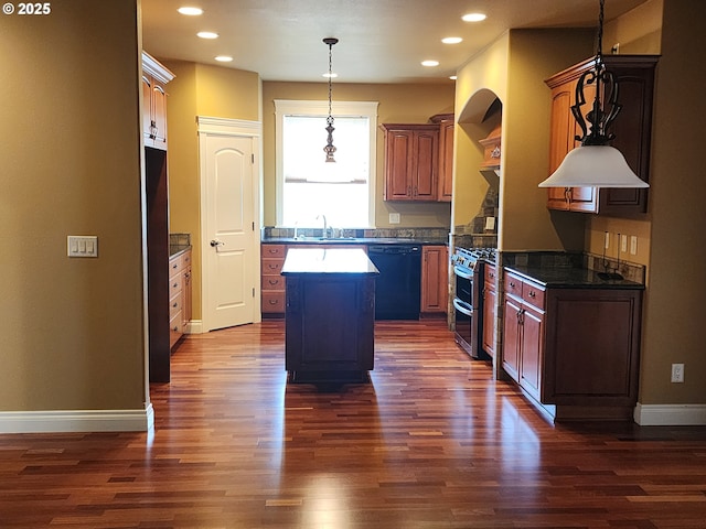 102 Sarah Bear Ln, Winston, OR 97496 - kitchen with dark countertops, a sink, range with two ovens, black dishwasher, and a kitchen island