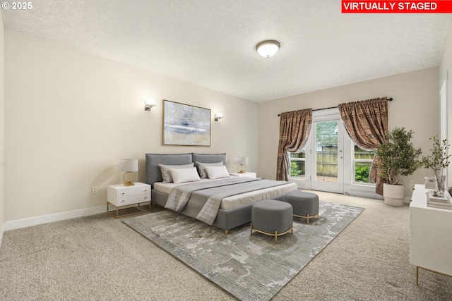 carpeted bedroom featuring access to outside, a textured ceiling, and baseboards