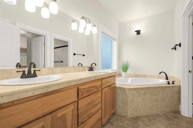 bathroom featuring double vanity, a garden tub, tile patterned flooring, and a sink