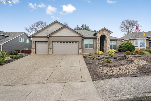 view of front of house featuring a garage, stone siding, and driveway