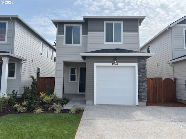 2313 SW 5th Pl, Battle Ground, WA 98604 - view of front facade with fence, concrete driveway, and an attached garage