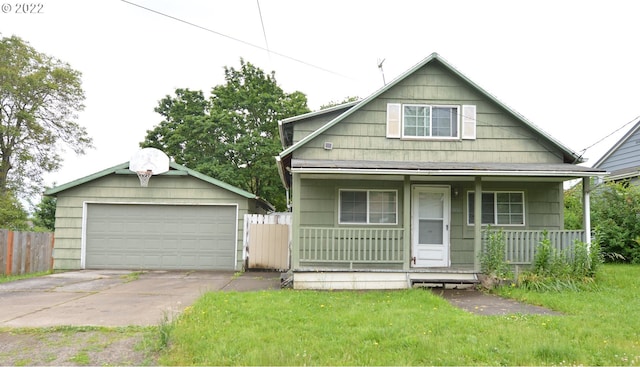 bungalow with covered porch, an outbuilding, a garage, and fence