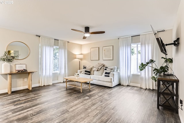 living room featuring ceiling fan and dark hardwood / wood-style flooring