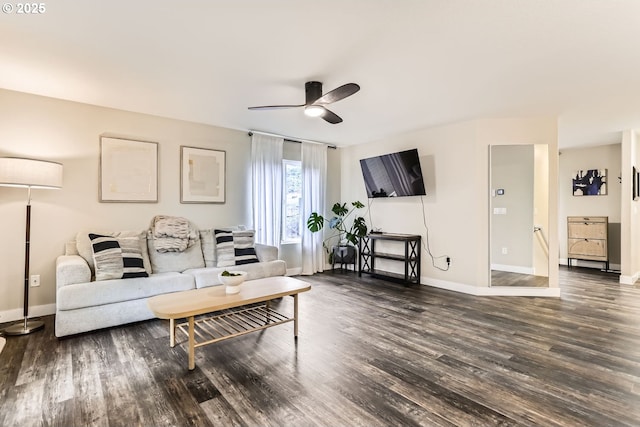 living room featuring ceiling fan and dark hardwood / wood-style flooring