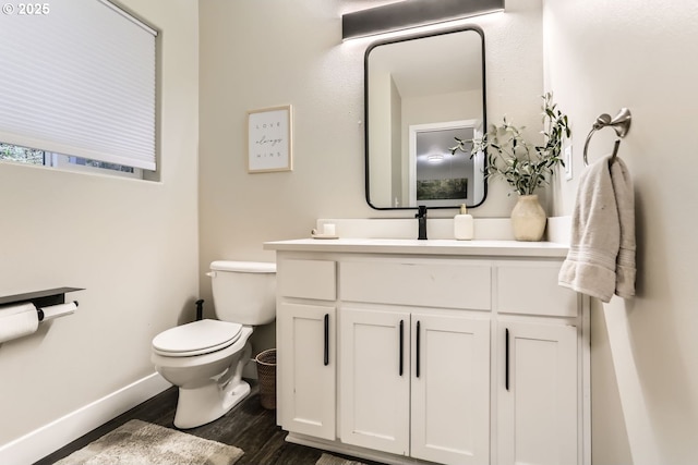 bathroom featuring hardwood / wood-style flooring, vanity, and toilet