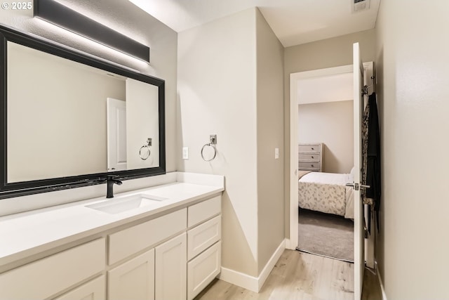 bathroom featuring vanity and hardwood / wood-style flooring