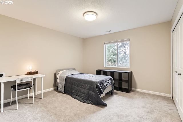 carpeted bedroom featuring a closet