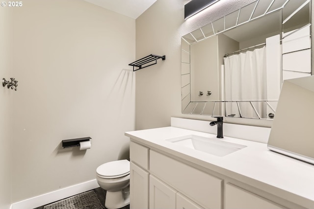 bathroom with tile patterned flooring, vanity, and toilet