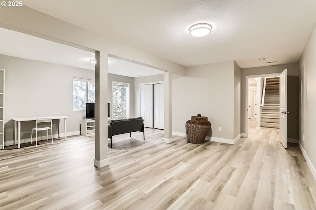 interior space featuring a textured ceiling and light hardwood / wood-style flooring