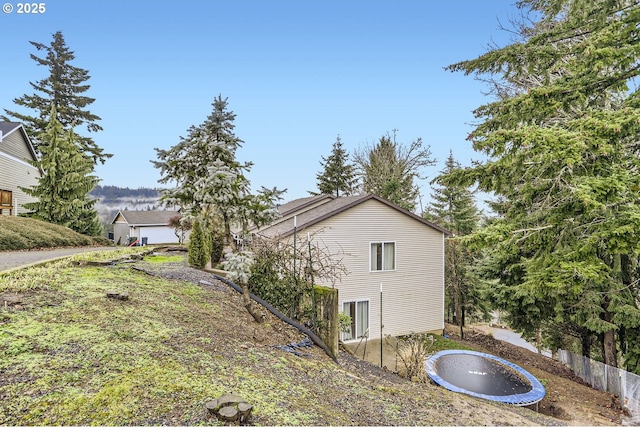 view of side of property featuring a trampoline